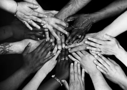 A black and white image of many diverse people
