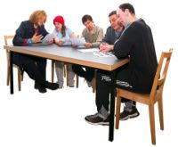 A group of professionals sitting round a table trying to make a best interest decision about a client.